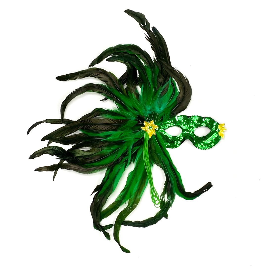 A green mask with green feathers flowing to the side